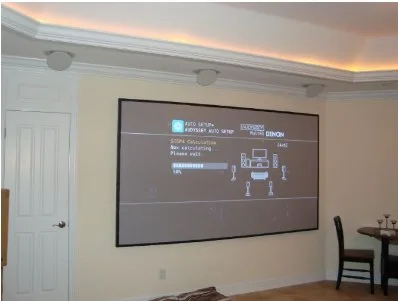 Home theater with a projector screen and surround sound speakers installed by DCSI Inc.