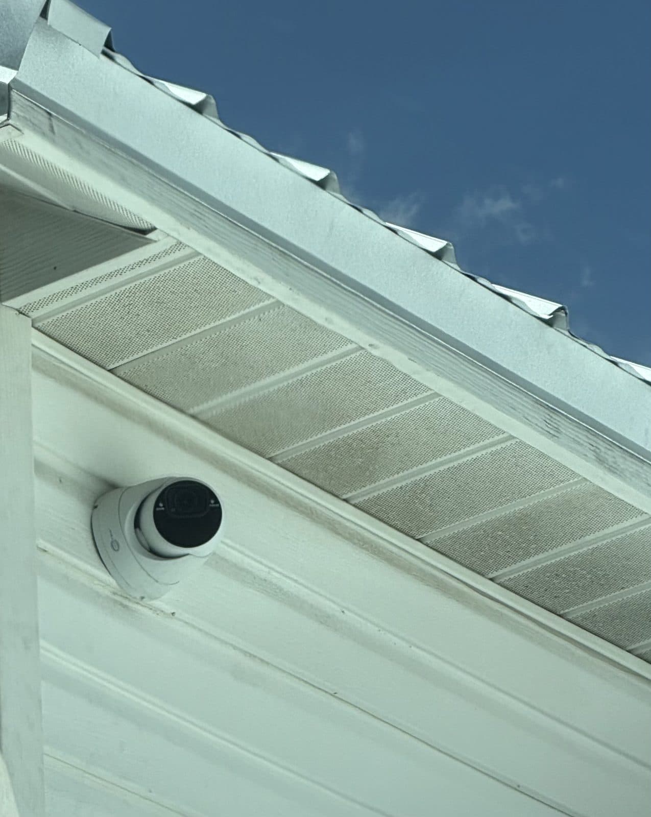 Dome security camera installed under a home soffit